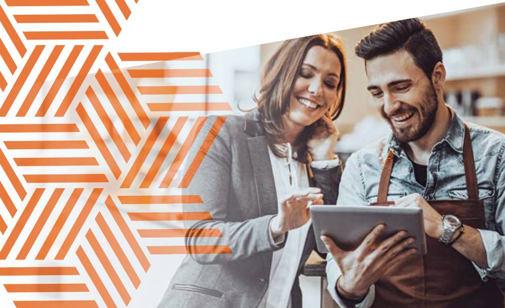 5 Retirement Mistakes Small-Business Owners Make (And How to Avoid Them) 1 Smiling couple looking at a tablet together in a shop